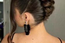 a top knot with a braided back looks very unusual and eye-catchy, and face-framing hair accents the eyes