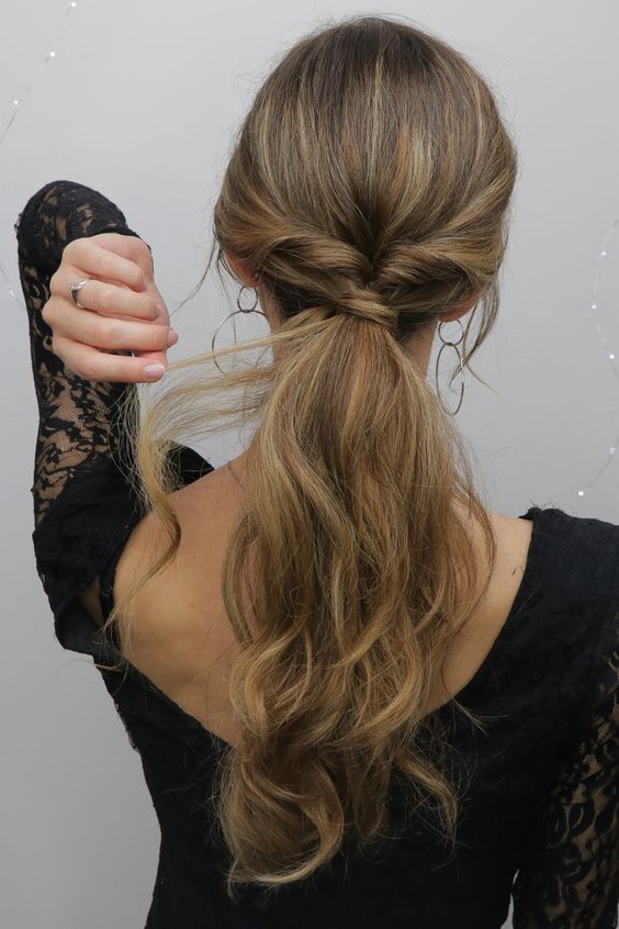 a twisted low ponytail with messy waves down is a cool and lovely solution to rockk for the holidays