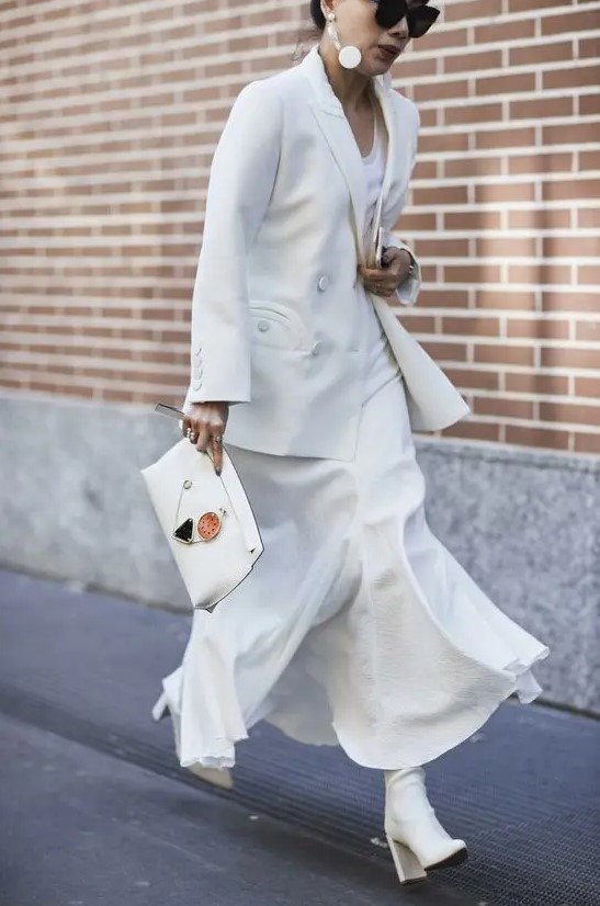 a white maxi dress, a white jacket, white boots and a clutch for an elegant winter bridal shower look