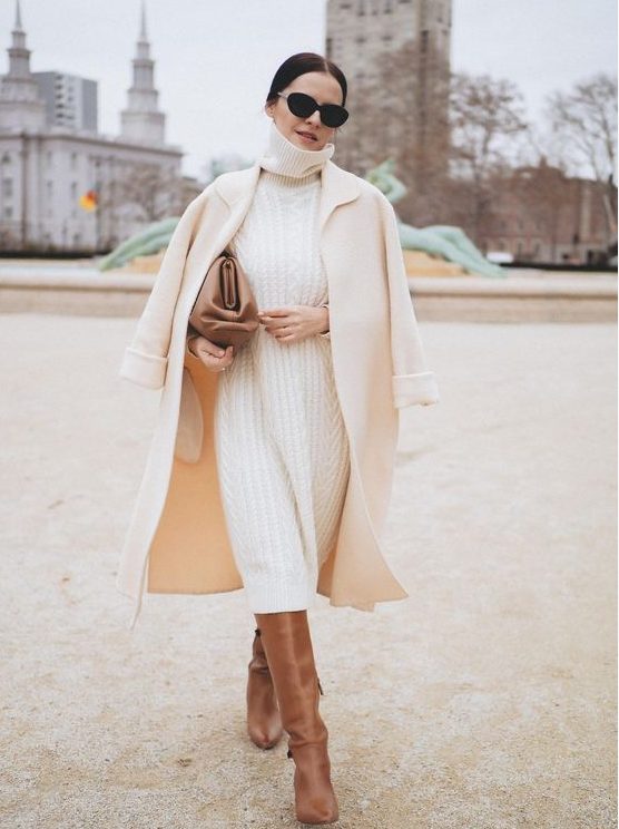 a white patterned midi sweater dress, brown boots, a neutral midi coat and a brown bag for a comfy winter bridal shower look