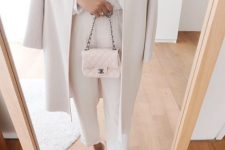 a white polka dot blouse, pants, two tone shoes, a coat and a light pink pink crossbody bag