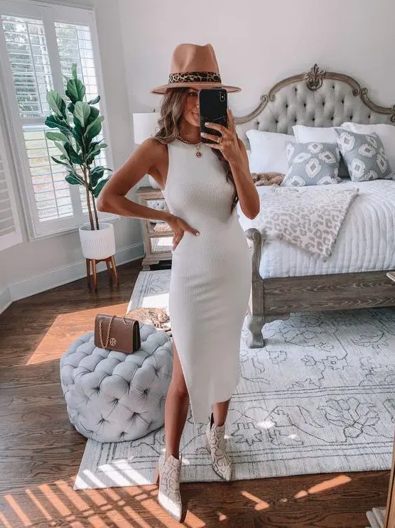 a white ribbed midi dress with a side slit, snakeskin print boots and a hat are a great look for a bride-to-be