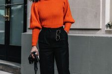 an orange sweater, black high waisted pants, neutral shoes, statement earrings for a lovely look in the fall