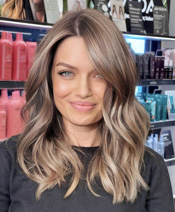 Beautiful light brown medium length hair with a slight ombre effect, with waves and a shiny finish is amazing