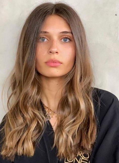 beautiful long brown hair with caramel balayage, with waves, is a chic and stylish solution to rock