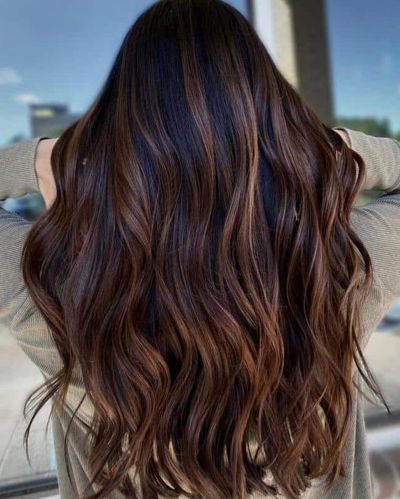 dark long wavy hair with caramel balayage is a gorgeous and chic way to give dimension to your super long hair