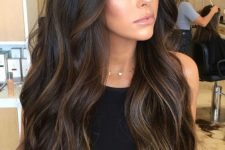 extra long and volumetric dark brown hair with delicate caramel balayage and messy sligth waves is a fantastic idea to rock