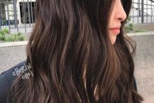 extra long dark brown hair with a bit of highlights to give dimension to the hair, with slight waves, is a catchy and cool idea