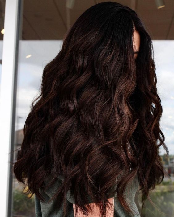 Jaw dropping long dark brown volumetric hair with waves just brings that wow factor and inspires to try the color