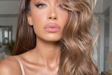jaw-dropping long light brown hair with darker root, waves and volume looks fantastic