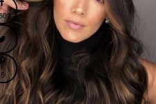 long and volumetric dark brown hair with caramel balayage and waves is a fatnastic idea to try, and this contrast will catch an eye
