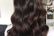 long and volumetric dark brown hair with waves is a fab idea to rock, it looks very pretty and catches an eye