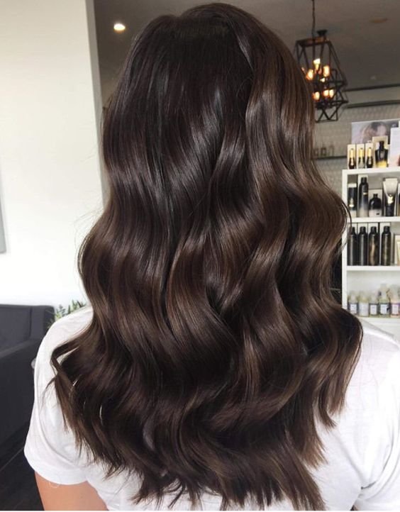 long and volumetric dark brown hair with waves is a fab idea to rock, it looks very pretty and catches an eye