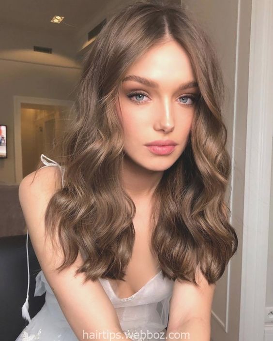 long and volumetric light brown hair with volume and waves is a timeless solution if you don't want too bold shades