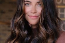 long dark brown, almost black hair with caramel balayage and waves, with volume, is a catchy and stunning idea