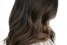 long dark brown hair with caramel balayage, waves and volume, is a stunning solution to rock right now