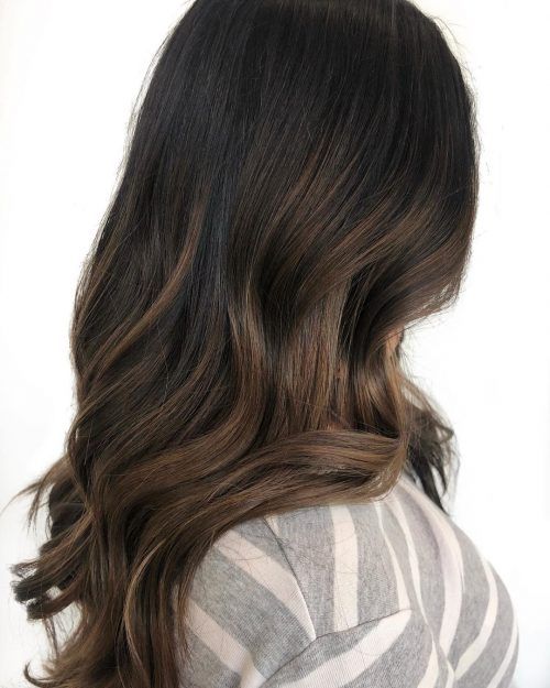 long dark brown hair with caramel balayage, waves and volume, is a stunning solution to rock right now
