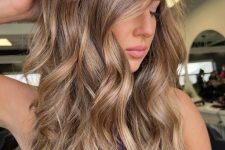 long layered light brown hair with golden blonde balayage and waves is amazing and catchy