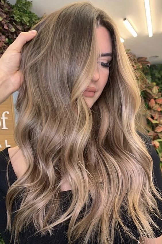long light brown hair with blonde balayage, waves and volume is a lovely idea to rock right now
