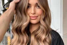 long light brown hair with caramel balayage, waves and volume is a cool and catchy idea to rock