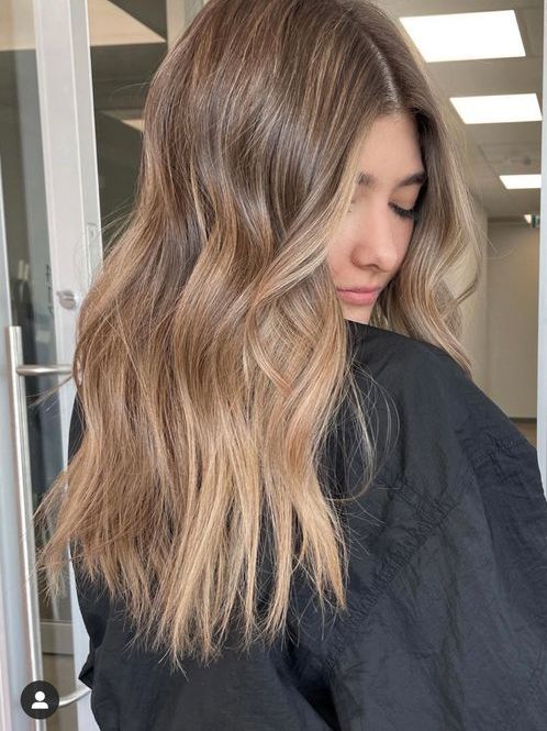 long light brown hair with caramel balayage, waves and volume, is a lovely and chic idea to rock right now