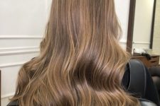 long light brown hair with honey blodne balayage and waves and volume is an amazing idea to rock