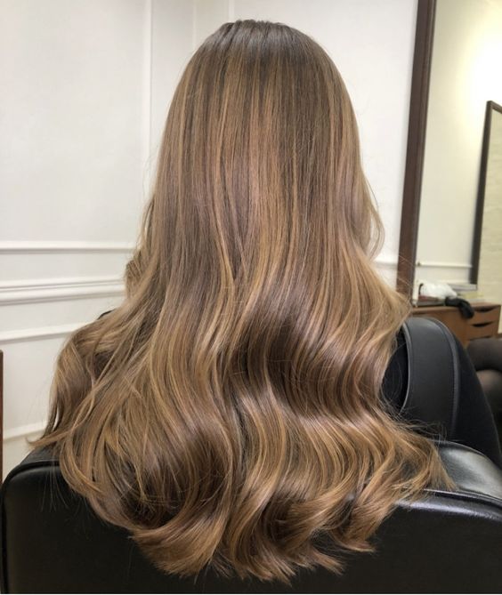 long light brown hair with honey blodne balayage and waves and volume is an amazing idea to rock