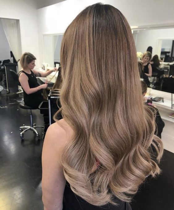 long light brown hair with waves and volume is a lovely idea for a chic and elegant look