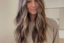 long mousy brown hair with blonde balayage, volume and waves is always a cool and chic idea to rock