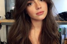 lovely dark brown long hair with waves and a lot of volume looks super chic and very cute