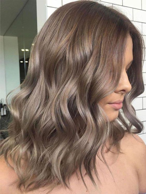 Medium length ashy brown hair with waves is a stylish and chic idea if you love such shades