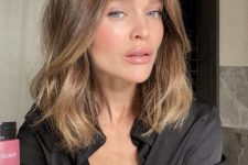 medium-length light brown hair with a slight ombre effect to blonde, waves and volume is fantastic