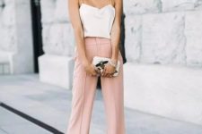 pink wideleg pants, a creamy spaghetti strap top, statement earrings, a small clutch with appliques for a casual summer wedding