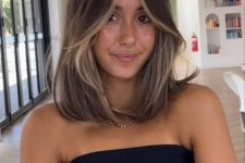 pretty brunette shoulder-length hair with long curtain bangs and blonde contouring