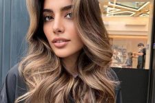pretty long brown hair with caramel balayage, waves and volume looks spectacular