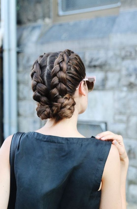 two voluminous braids with large low buns are a catchy and bold solution for a bold holiday look