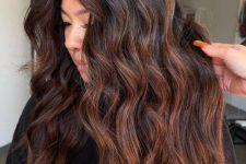 very long dark brown hair with copper balayage, waves and volume, is a catchy and cool idea to rock