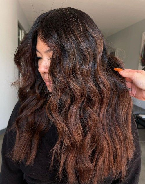 very long dark brown hair with copper balayage, waves and volume, is a catchy and cool idea to rock