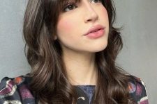 05 a dark brunette long butterfly haircut with wispy to bottleneck bangs and waves is a cool and girlish idea to try