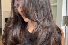 08 a dark brunette butterfly haircut with a shiny finish and wavy ends is a catchy and stylish idea to try