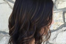 22 a black wavy bob with subtle bronde balayage gets a dimension at once thanks to these highlights
