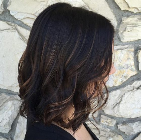 a black wavy bob with subtle bronde balayage gets a dimension at once thanks to these highlights