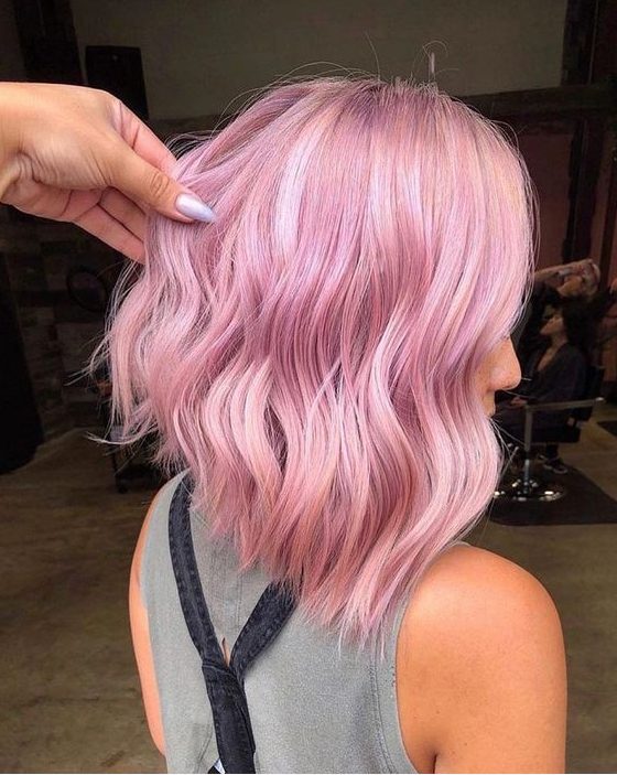 a lovely A-line wavy pink long bob will catch an eye both with the color and asymmetry