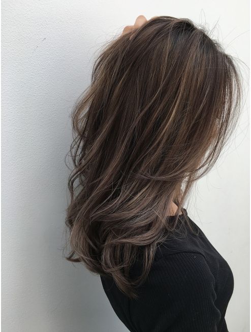 beautiful long dark hair with subtle blonde highlights that instantly give dimension to the hair