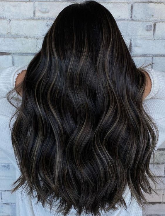 long and fabulous black hair with delicate bronde balayage and waves is a gorgeous idea to try