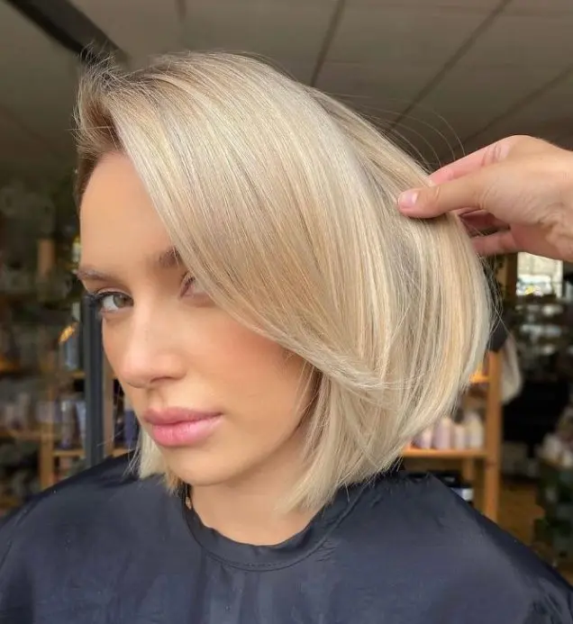 A blonde chin length bob with curtain bangs is a very up to date and fresh idea to rock right now