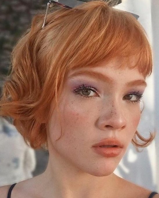 a ginger red jaw-length bob with layered bangs and waves is a catchy and fresh solution, and the color inspires