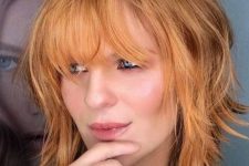 43 a ginger shaggy medium bob with a darker root and a fringe is a very cool and bold idea to make a statement with color