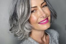 a beautiful midi bob in brown with a lot of silver grey balayage blending naturally with grey hair, with curled ends, is a chic hairstyle