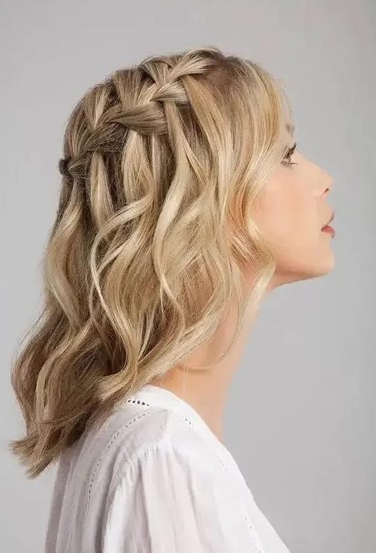 a blonde medium length half updo with a braided top and waves down is a stylish boho party look idea